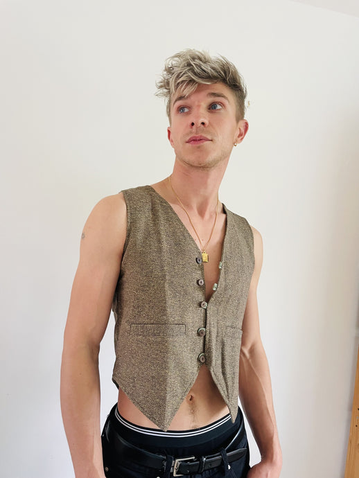 Emma's Emporium Gold Flecked Waistcoat. Unisex fit for men and women, these unique waistcoats really stand out. Tweed inspired lurex woven fabric with gold flecks running through, with cotton lining, front pockets and natural coconut buttons.